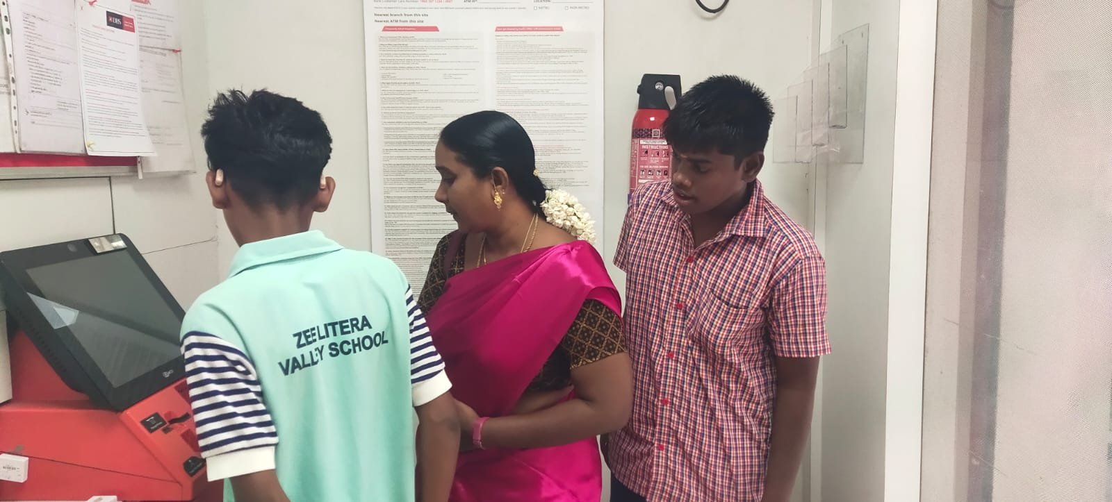Students learning to use a bank ATM as part of community life skills